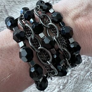 Black beaded bracelet with silver chain detail. GUC